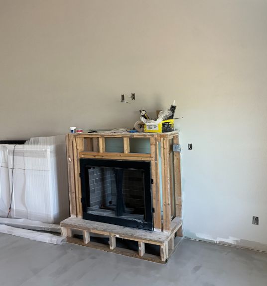 Fireplace box framed in raw lumber before finishing